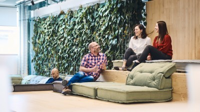A group of coworkers relaxing in the social area of a modern office.